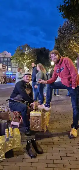 An evening shoeshine with a guest in a pink jacket.