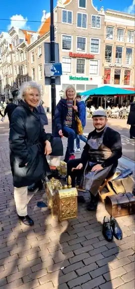 A guest beside the shoeshine box in the city.