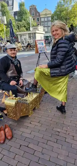 A guest in a yellow skirt during an outdoor shoeshine.