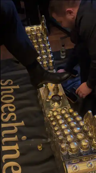 Shoeshining by hand at the brass shoeshine box.